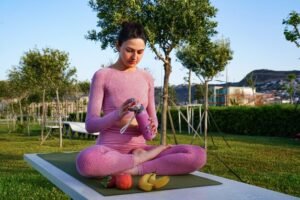 young-woman-purple-shirt-trousers-grass-daytime-inside-green-park-meditating_140725-14115-300x200 100 Benefits of Yoga